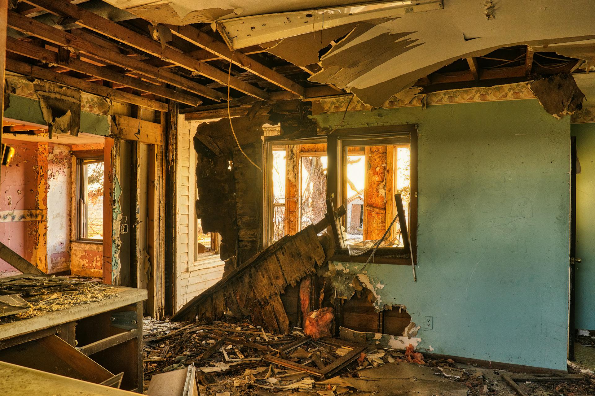 Severely damaged home interior with collapsed ceiling and structural debris before reconstruction by DryMetrics in Central Florida