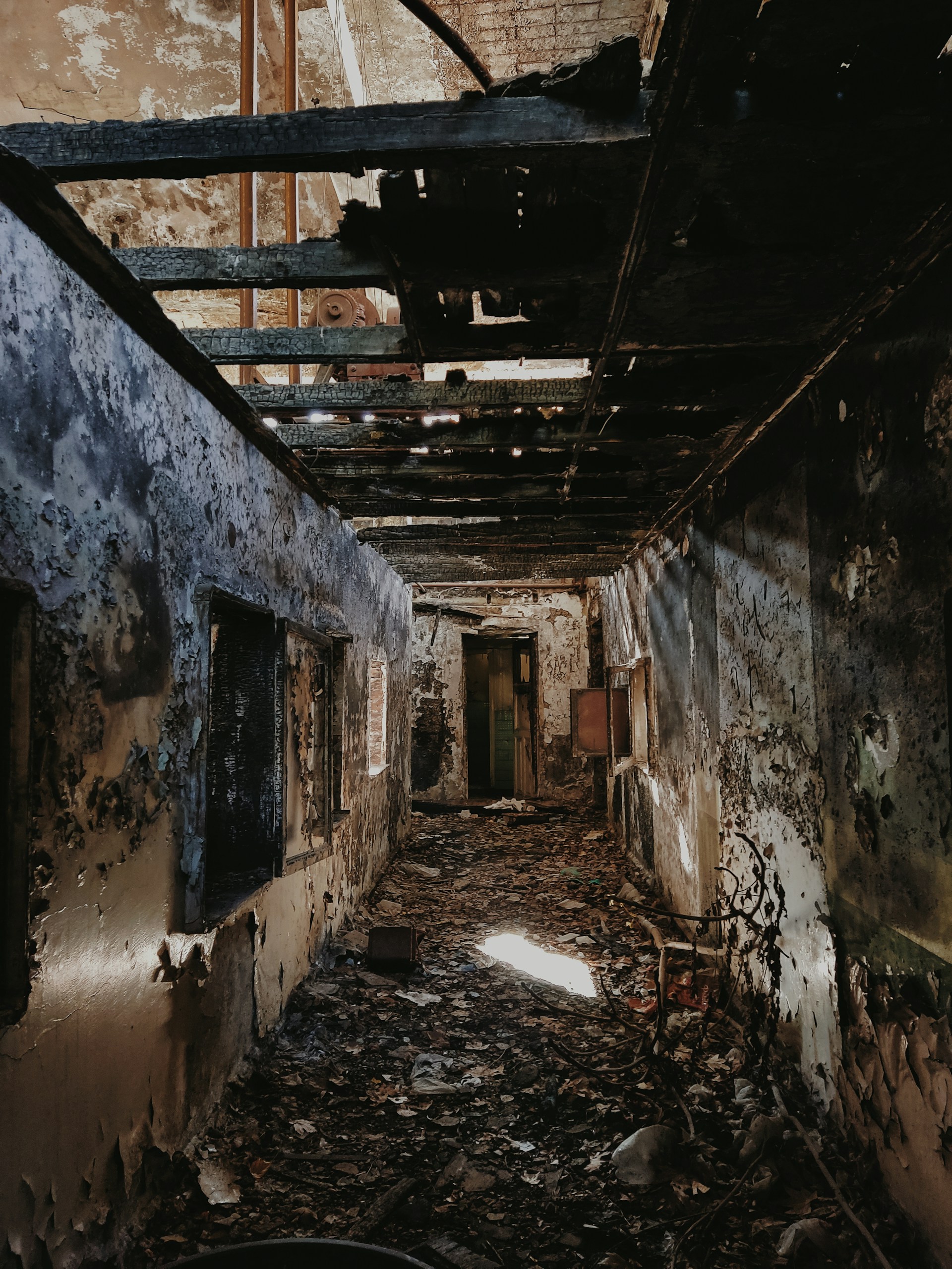Severely fire-damaged home interior showing charred wooden beams and smoke-blackened walls requiring professional fire and smoke restoration in Central Florida